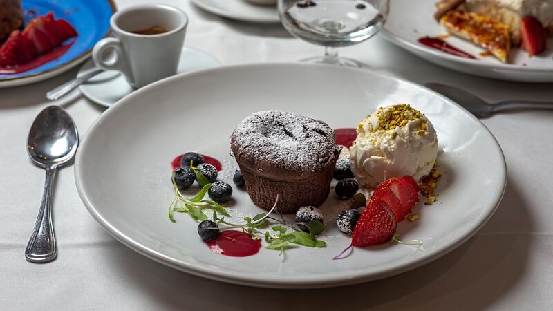 Chocolate cake with side of ice cream and berries