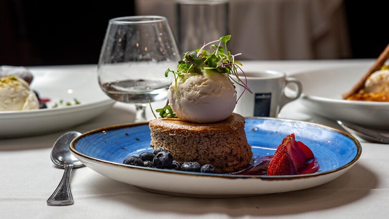 Greek walnut cake dessert topped with vanilla ice cream